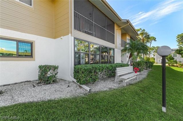 doorway to property with a lawn