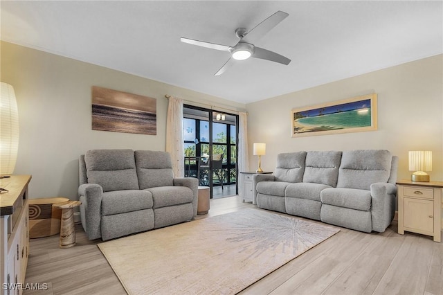 living room with ceiling fan and light hardwood / wood-style floors