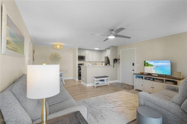 living room with light hardwood / wood-style flooring and ceiling fan