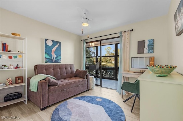 living room with ceiling fan and light wood-type flooring