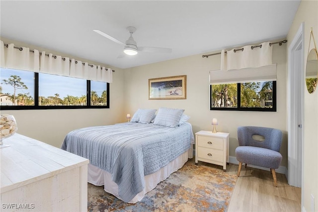 bedroom with hardwood / wood-style floors and ceiling fan