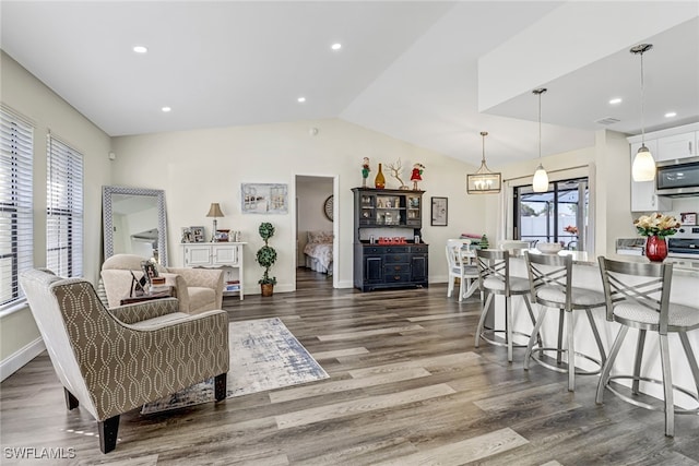 living room with dark wood-type flooring and vaulted ceiling