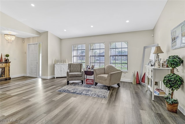 living area featuring hardwood / wood-style floors and a chandelier