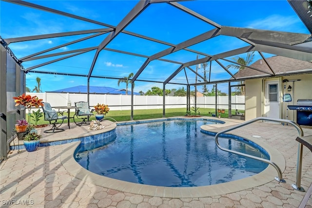 view of swimming pool featuring grilling area, a lanai, and a patio area