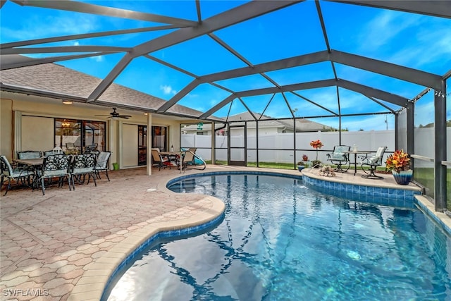 view of pool featuring ceiling fan, a patio area, and a lanai