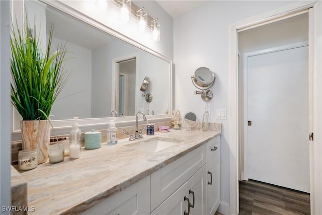 bathroom featuring hardwood / wood-style flooring and vanity