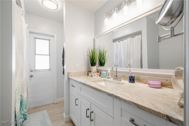 bathroom with vanity and wood-type flooring