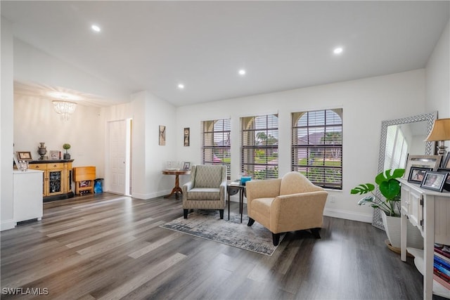 sitting room featuring dark wood-type flooring and an inviting chandelier