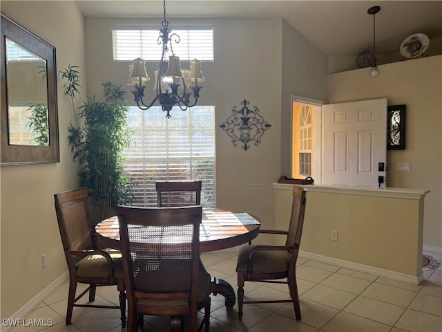 tiled dining room with a notable chandelier