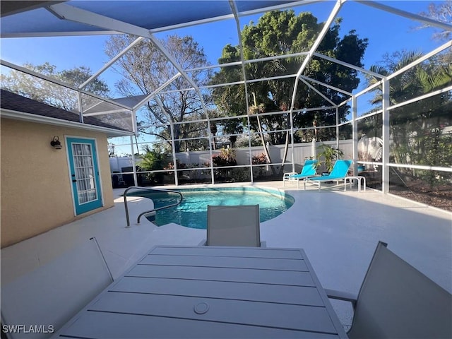 view of pool featuring a patio and glass enclosure