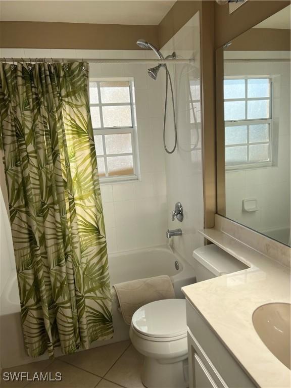 full bathroom featuring tile patterned flooring, vanity, shower / tub combo, and toilet