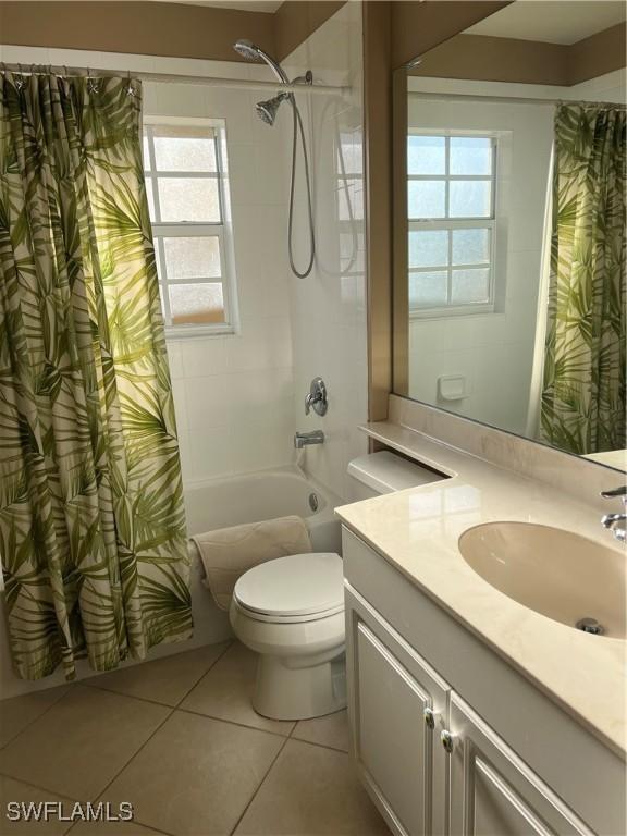 full bathroom with tile patterned flooring, shower / bath combo, toilet, and vanity