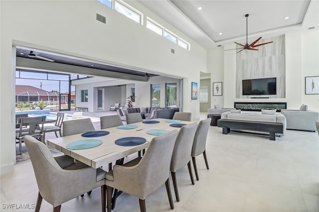 dining space with a towering ceiling, ceiling fan, visible vents, and recessed lighting