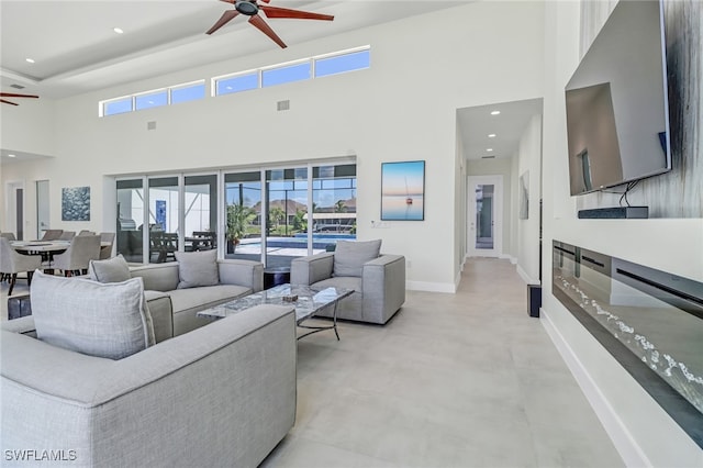 living area with plenty of natural light, ceiling fan, baseboards, and recessed lighting