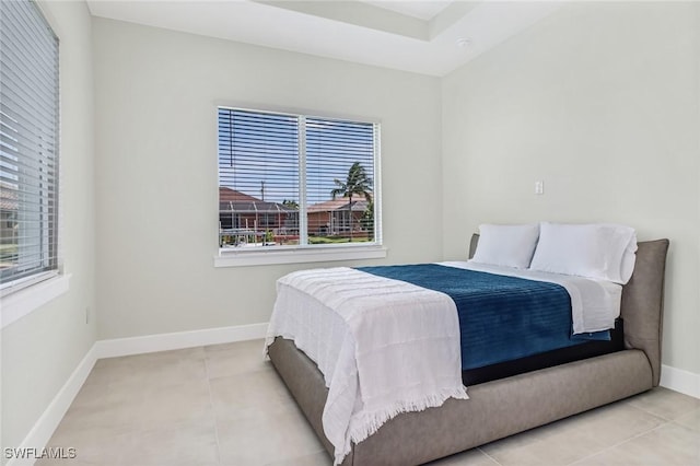 tiled bedroom featuring baseboards