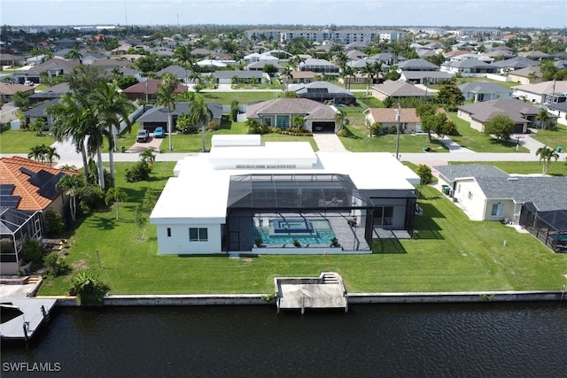 birds eye view of property with a water view and a residential view