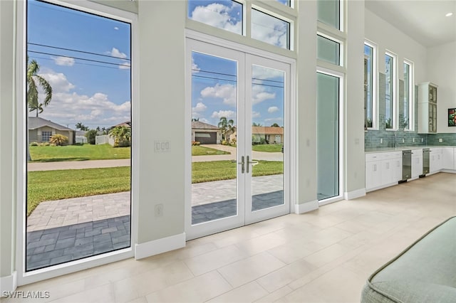 doorway to outside with baseboards and french doors