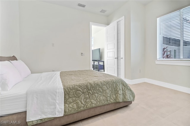 bedroom with baseboards and visible vents