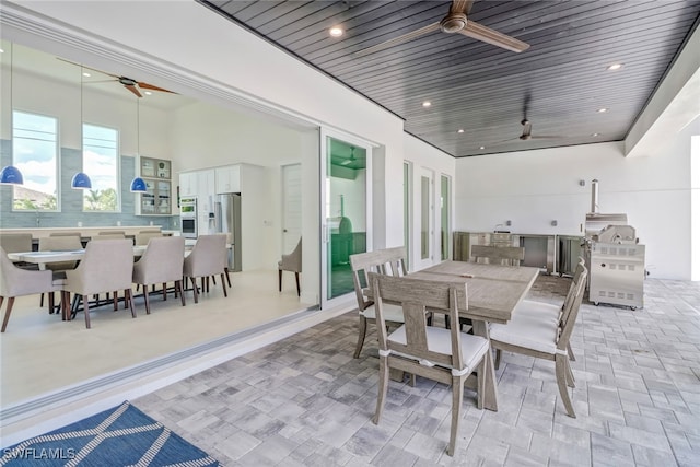 interior space featuring a ceiling fan, outdoor dining area, and an outdoor kitchen