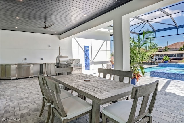 view of patio / terrace with outdoor dining area, a pool with connected hot tub, area for grilling, glass enclosure, and ceiling fan