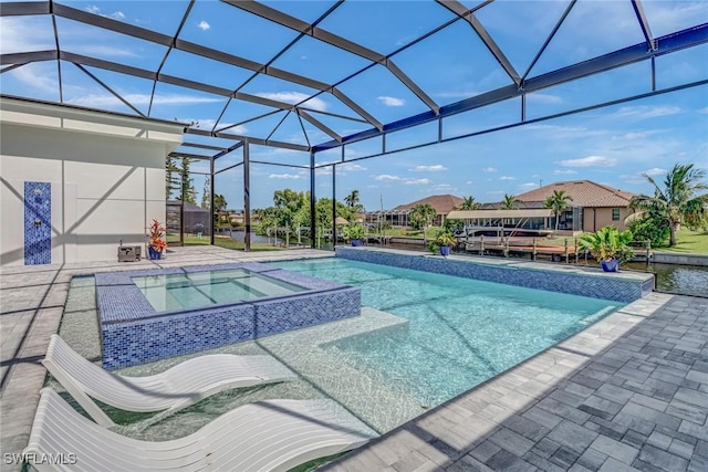 view of swimming pool featuring a lanai, a patio area, and a pool with connected hot tub