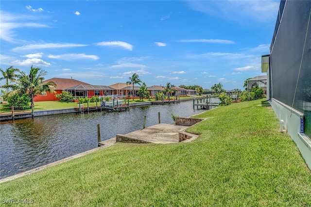 view of dock featuring a lawn, a water view, a lanai, and a residential view