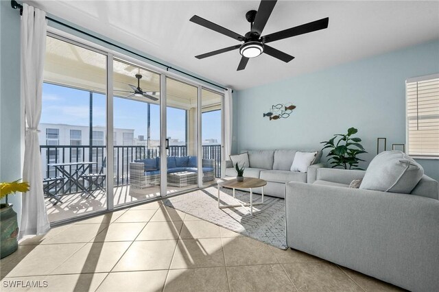 tiled living room with a wealth of natural light and ceiling fan