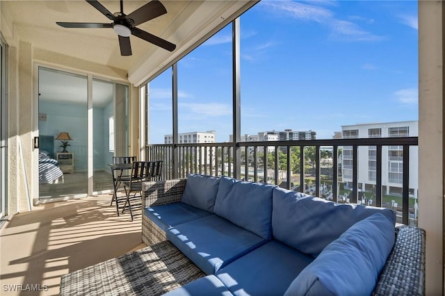 sunroom featuring ceiling fan