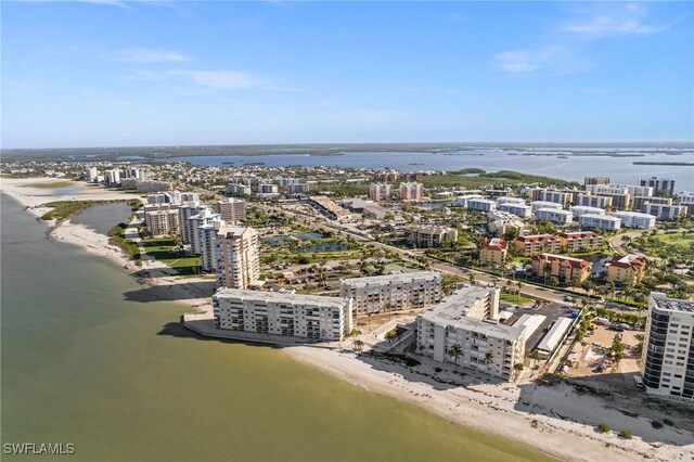 birds eye view of property with a water view and a beach view