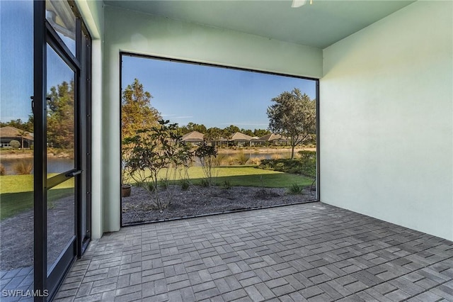 unfurnished sunroom with a water view