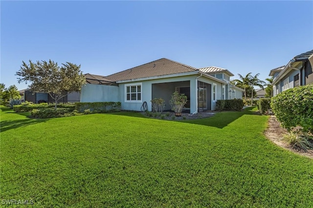 back of house featuring a lawn