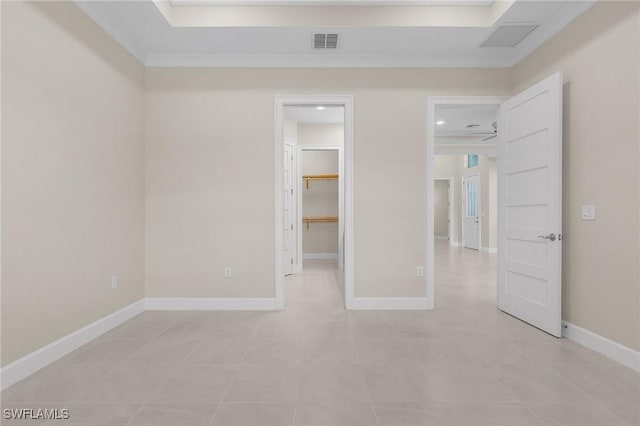 unfurnished bedroom featuring a walk in closet and light tile patterned floors