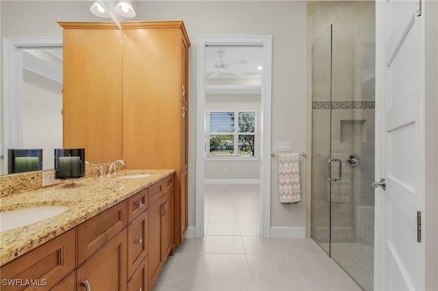 bathroom featuring tile patterned floors, vanity, ceiling fan, and an enclosed shower