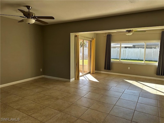 tiled empty room featuring a wealth of natural light and ceiling fan