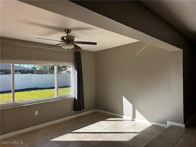 unfurnished room featuring tile patterned floors and ceiling fan