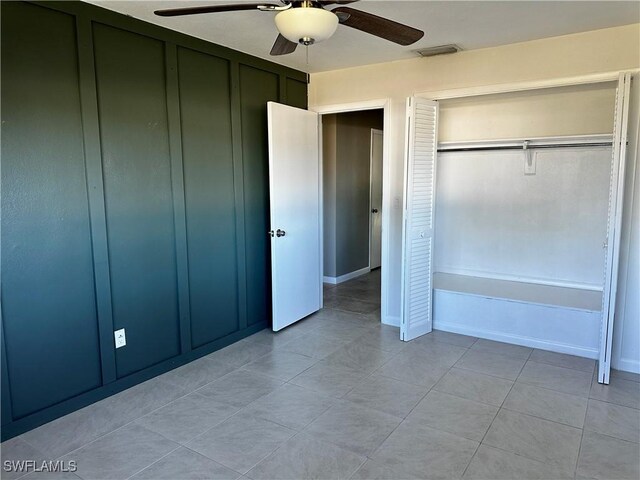 unfurnished bedroom featuring light tile patterned floors and ceiling fan