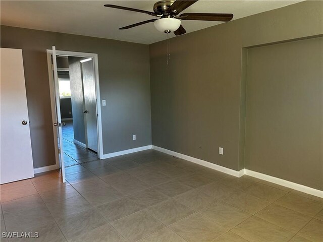 tiled empty room with ceiling fan