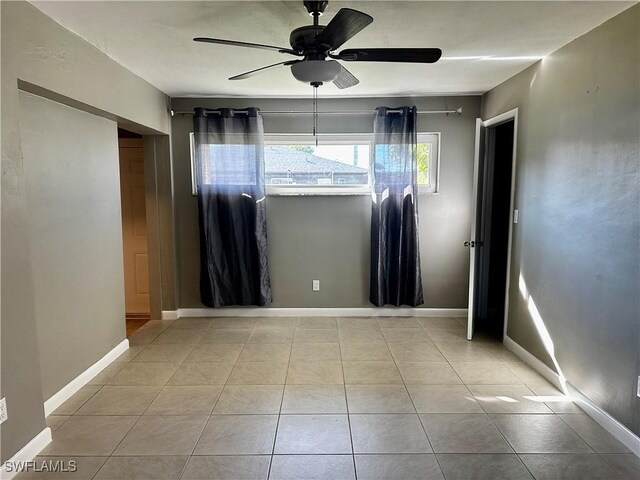 unfurnished room featuring light tile patterned floors and ceiling fan