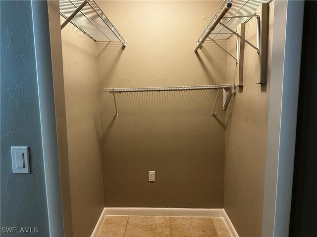 spacious closet featuring tile patterned flooring