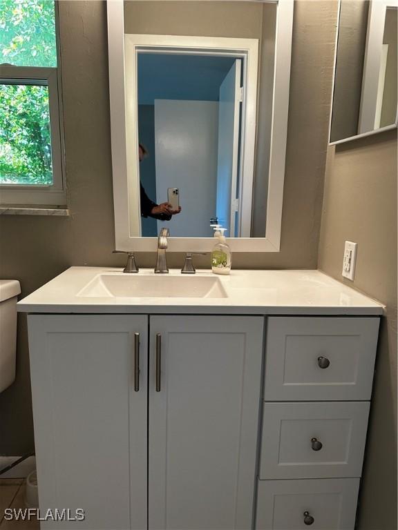 bathroom with vanity and toilet