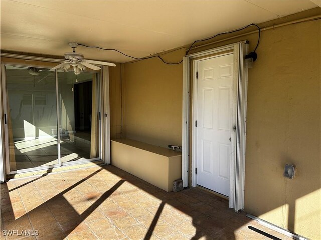 interior space with ceiling fan