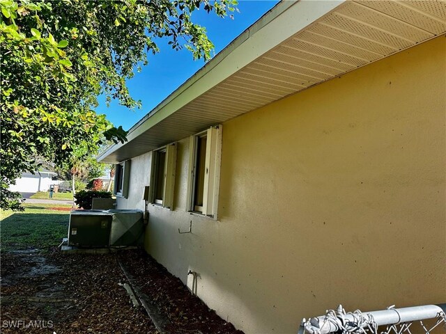 view of side of property featuring central air condition unit