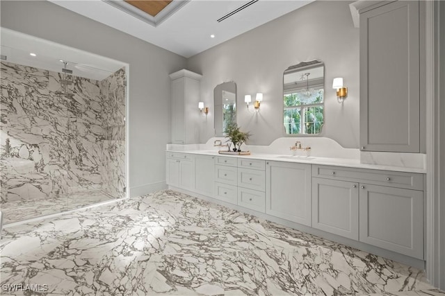 bathroom featuring a tile shower and vanity