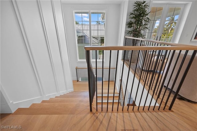 staircase featuring french doors and wood-type flooring