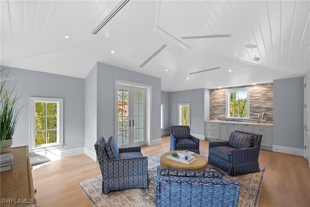 living area featuring wooden ceiling, lofted ceiling, and light wood-type flooring