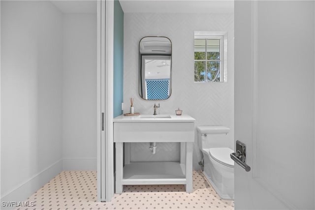 bathroom featuring sink and toilet