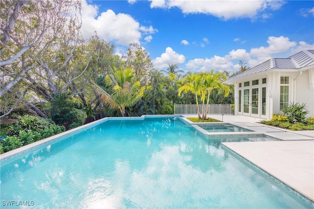 view of pool featuring an in ground hot tub, french doors, and a patio