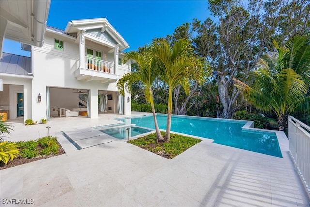 view of swimming pool featuring a patio area and an in ground hot tub