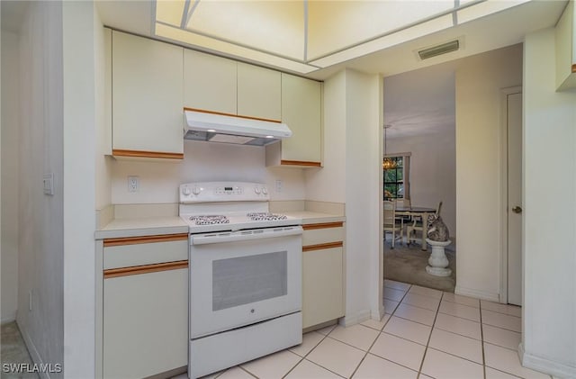 kitchen with light tile patterned flooring and white electric stove