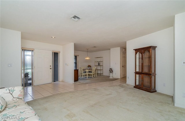 unfurnished living room featuring light carpet